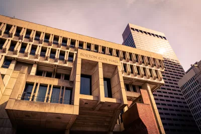 Looking up at modernist/brutalist Boston City Hall building bathed in golden hour light