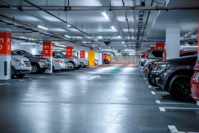 Underground parking garage full of parked cars.