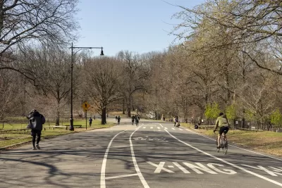 People walking and on bikes on paved multiuse path in Prospect Park, Brooklyn, New York City.