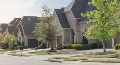 View of brick two-story houses in Dallas suburb