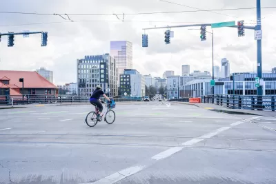 Person on bike in empty intersection in Portland, Oregon.