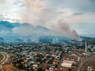 Aerial view of Lahainaluna neighborhood with smoke from fires in Maui, Hawaii.