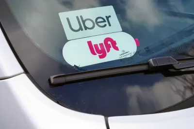 Clpse=up of Uber and Lyft stickers inside a car windshield.