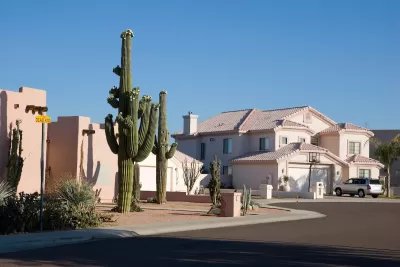 Suburban Phoenix single-family homes in a cul-de-sac, one with large saguaro cactus in front yard