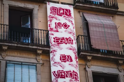 Hand painted fabric "Barcelona is not for sale" in Spanish banner hung on a building in Barcelona, Spain