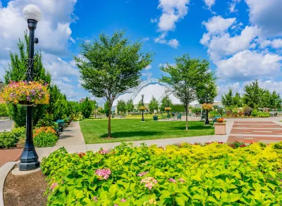 Lush Five Rivers Metropark in Dayton, Ohio with flowers and green trees on a sunny day.