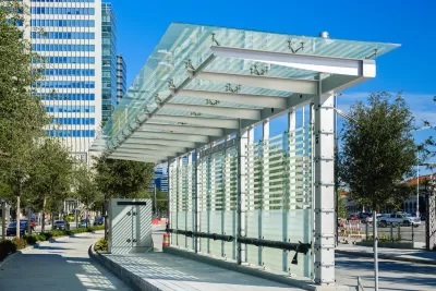 White metal and glass bus shelter at station with separated bus lane in downtown Houston, Texas