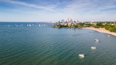 Lake Erie waterfront with many small boats and Cleveland, Ohio buildings in background.