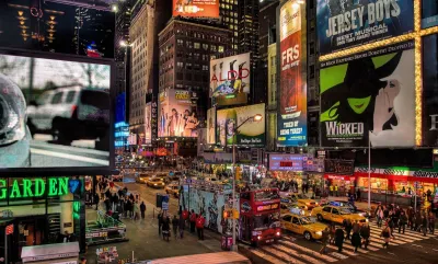 Times Square with Broadway billboards at night.