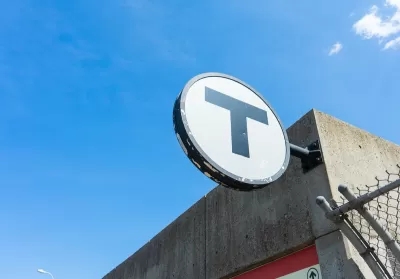 CLose-up of MBTA "T" logo on building.