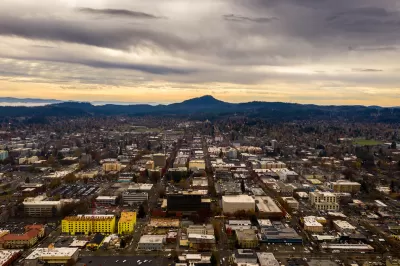 Aerial view of Eugene, Oregon at dusk with mountains in background.