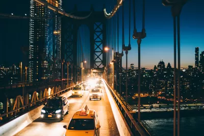 View of traffic on bridge going into Manhattan, New York City at night.