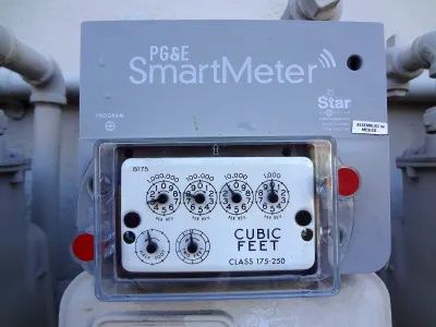 Close-up on PG&E "SmartMeter" electricity meter on side of building.