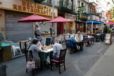 Patrons at restaurant in New York City eating at ourdoor tables in closed-off alleyway during Covid-19 pandemic in 2020.