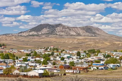 View of small town of Craig, Colorado with flat-topped mountain in background.