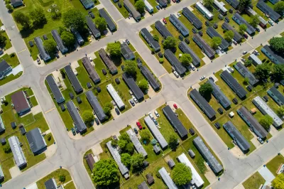 Aerial view of manufactured homes on green lawn.