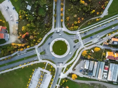 Bird's eye view of roundabout with two lanes and four branches.
