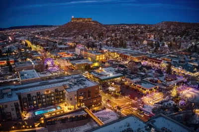 Aerial view of Castle Rock, Colorado at dusk in winter with Christmas lights.