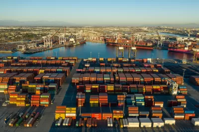 Aerial view of stacked shipping containers at golden hour at Port of Long Beach, California.
