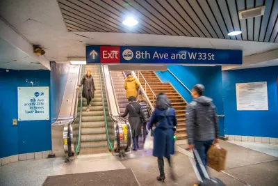 People walking up and down stairs in New York City subway station.