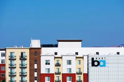 Colorful multistory apartment buildings next to BART transit station in Pleasanton, California.