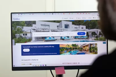 Close-up of computer screen with VRBO short-term rental platform site open.