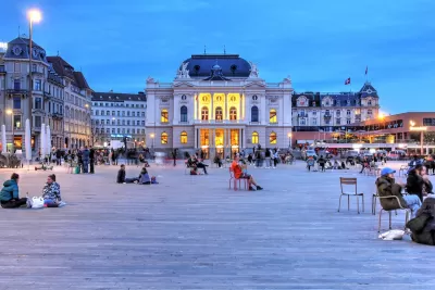People in large plaza in front of Zurich Opera House in Switzerland.