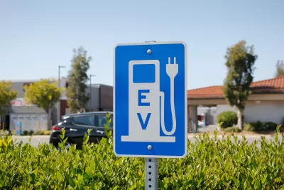 Blue sign with white gas pump symbol with electric plug and "EV"
