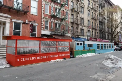 Row of outdoor dining kiosks in New York City during Covid-19 in winter. Kiosks are enclosed with plastc or plexiglass.