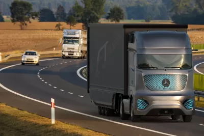Self-driving Mercedes semi truck on highway with white semi truck behind it