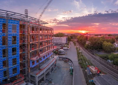Large building under construnction in downtown Charlottesville, Virginia at sunset.