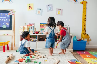Three toddlers playing in a colorful playroom