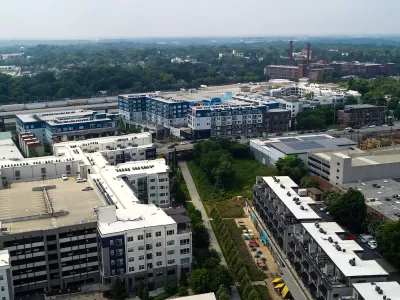 Aerial view of Atlanta BeltLine trail with colorful outdoor patio umbrellas and buildings.
