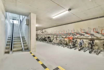 Bike parking in underground area with ramp for taking bikes upstairs.