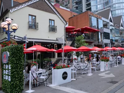 Outdoor dining patio with red umbrellas in Toronto, Canada