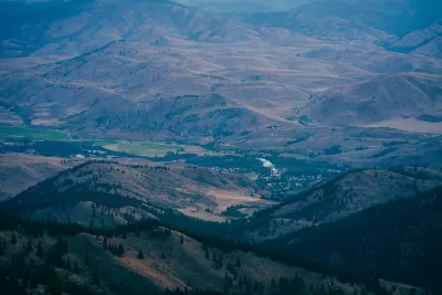 Aerial view of small rural community nestled in sprawling green valley in Washington State