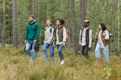 Diverse group of young people walking through forest