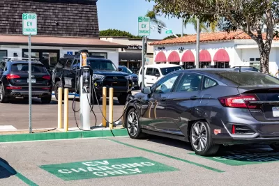 Car parked at EV charging station in parking lot in Carlsbad, California.