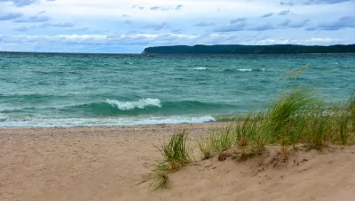 Turquoise blue water in Lake Michigan on tranquil sandy shoreline.