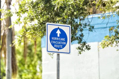 Blue and white "hurricane evacuation route" sign.