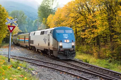 An eastbound Amtrak Empire Builder passes through the Cascade Mountains as the trees turn fall colors in Skykomish, WA