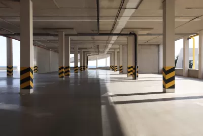Empty elevated parking garage with sunlight coming in.