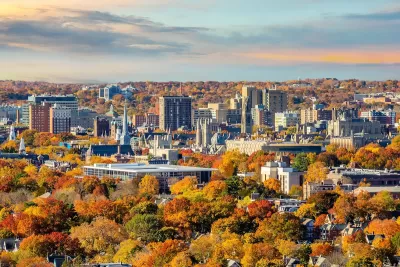 New Haven, Connecticut downtown skyline with fall foliage in foreground.