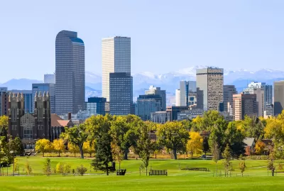 Denver, Colorado skyline with green lawn in the foreground.