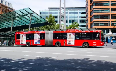 Red articulated public transit bus in Sydney, Australia.