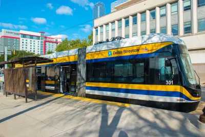 Blue, yellow, and white DART Dallas streetcar.