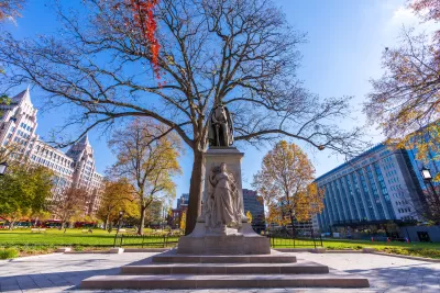 Statue in Franklin Square Park in Washington, D.C. with dry fall tree in background