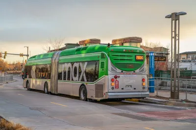 Green and silver Max BRT bus at station in Fort Collins, Colorado.