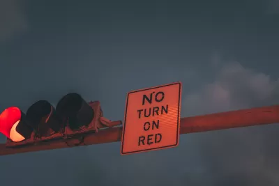 'No turn on red' sign attached to an overhead traffic light
