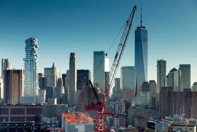 Red crane in foreground with New York City skyline in background.